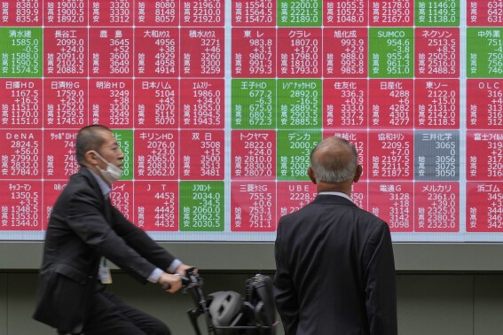 Asian shares mostly lower, trading in a narrow range with US markets closed for Memorial Day