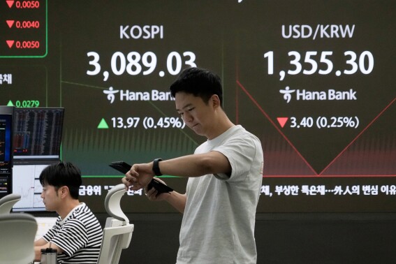 Asian shares mostly higher after US stocks hit another record as Tesla and Nike rally